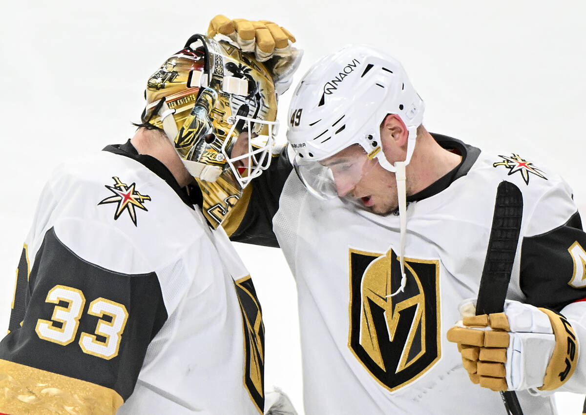 Vegas Golden Knights goaltender Adin Hill (33) is congratulated by teammate Ivan Barbashev (49) ...