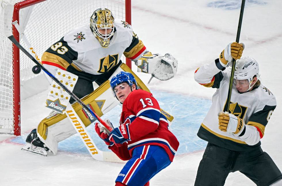 Montreal Canadiens' Cole Caufield (13) tries to knock down a loose puck as Vegas Golden Knights ...