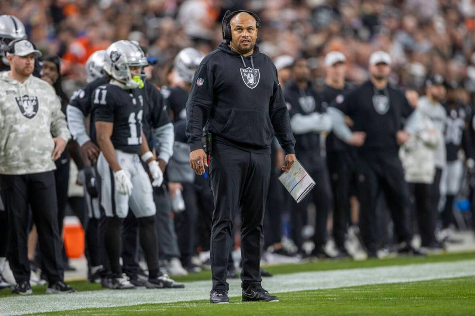 Raiders head coach Antonio Pierce looks to a replay screen after the team was penalized during ...