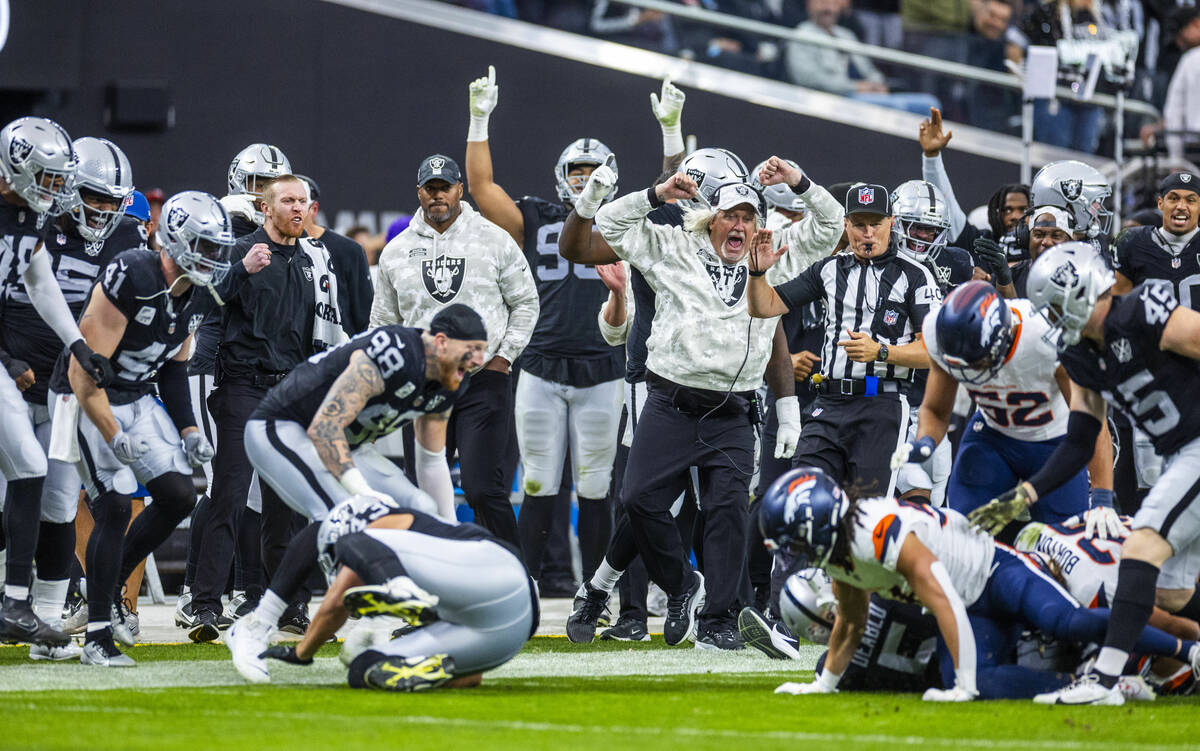 Raiders teammates celebrate linebacker Divine Deablo (5) tackle on the sidelines after a fake p ...