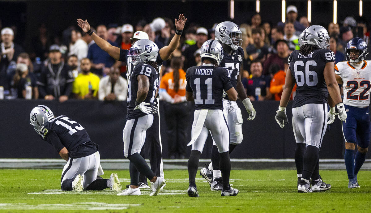 Raiders quarterback Gardner Minshew (15) is down after a sack with a hand injury against the De ...