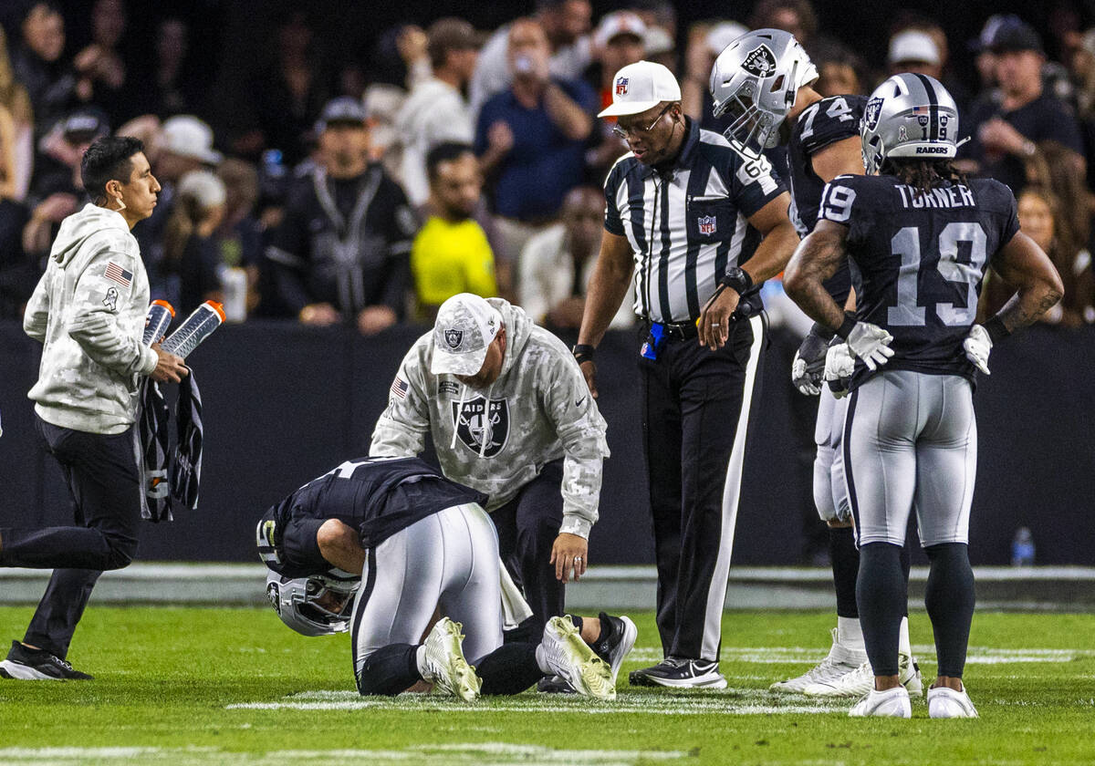 Raiders quarterback Gardner Minshew (15) is down after a sack with a hand injury against the De ...