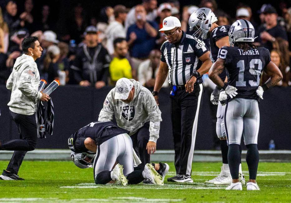 Raiders quarterback Gardner Minshew (15) is down after a sack with a hand injury against the De ...