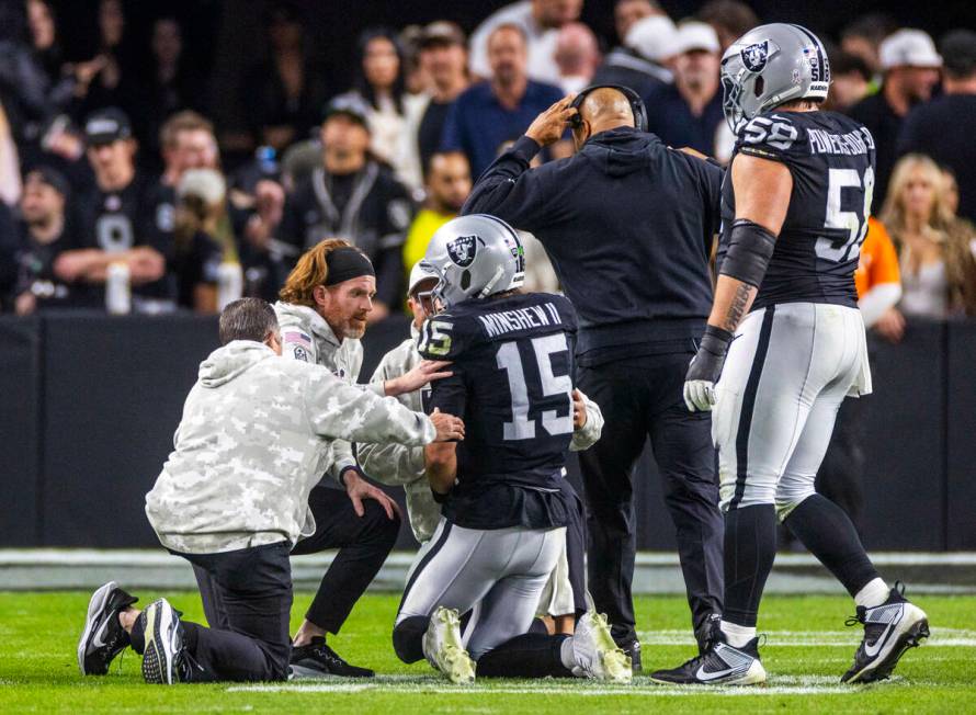 Raiders quarterback Gardner Minshew (15) is down after a sack with a hand injury against the De ...