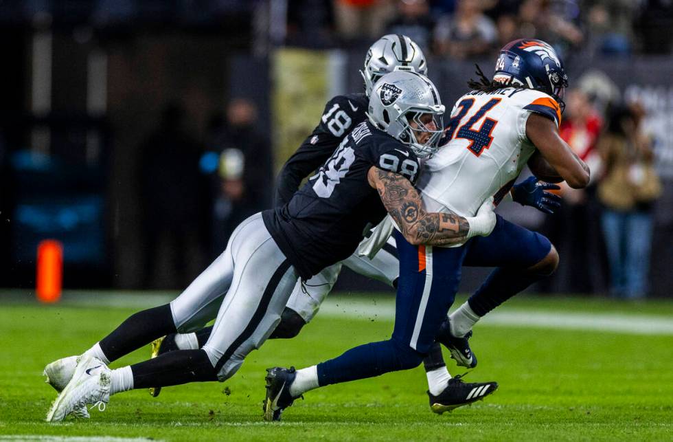 Raiders defensive end Maxx Crosby (98) stops Denver Broncos wide receiver Lil'Jordan Humphrey ( ...