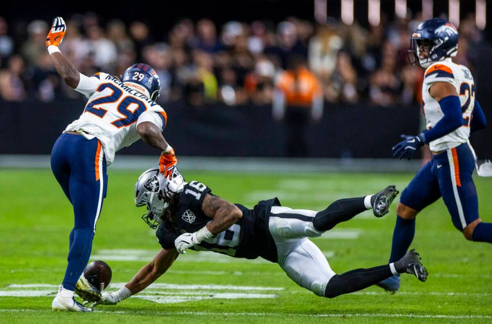 Raiders wide receiver Jakobi Meyers (16) misses a pass saw Denver Broncos cornerback Ja'Quan Mc ...