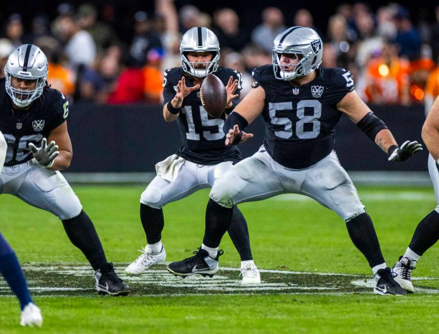 Raiders quarterback Gardner Minshew (15) awaits the snap against the Denver Broncos during the ...