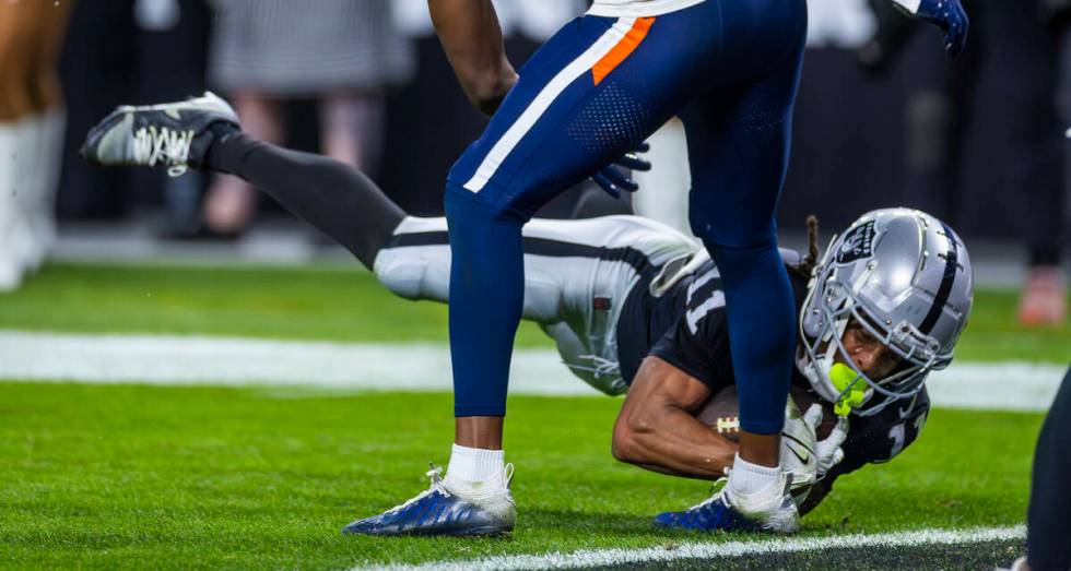 Raiders wide receiver Tre Tucker (11) dives for the end zone but comes up short against the Den ...