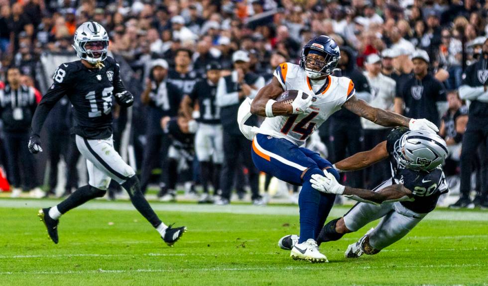 Denver Broncos wide receiver Courtland Sutton (14) shakes off Raiders safety Isaiah Pola-Mao (2 ...