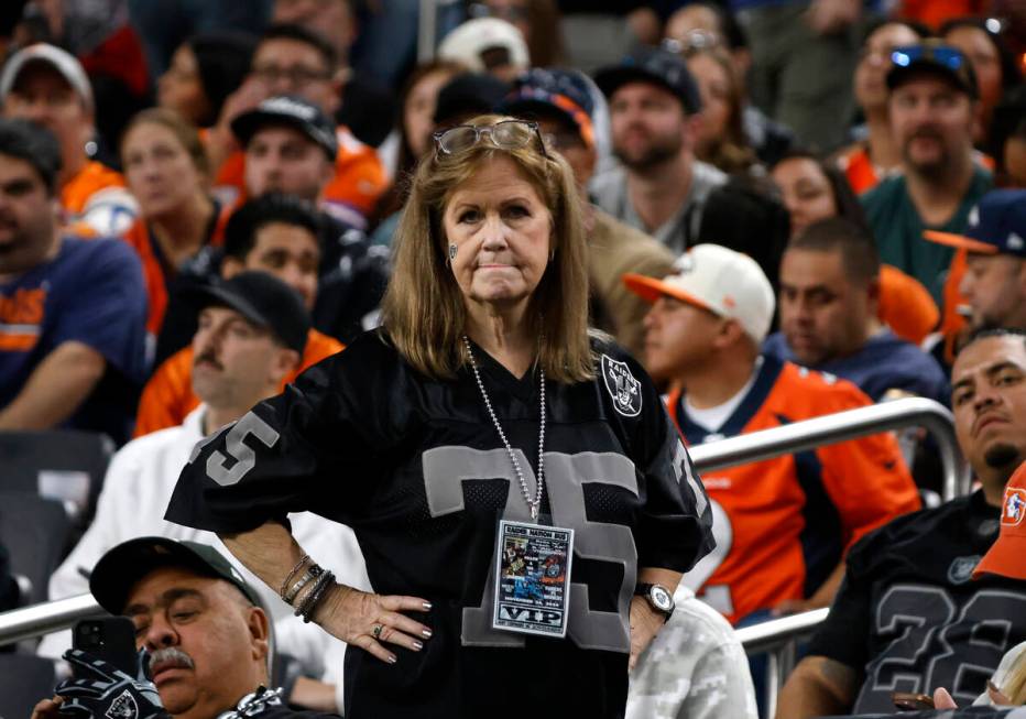 A Raiders fan watches the last minutes of an NFL game against the Denver Broncos at the Allegia ...