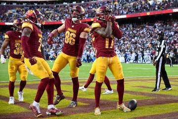 Washington Commanders wide receiver Terry McLaurin (17) celebrates after scoring an 86-yard tou ...