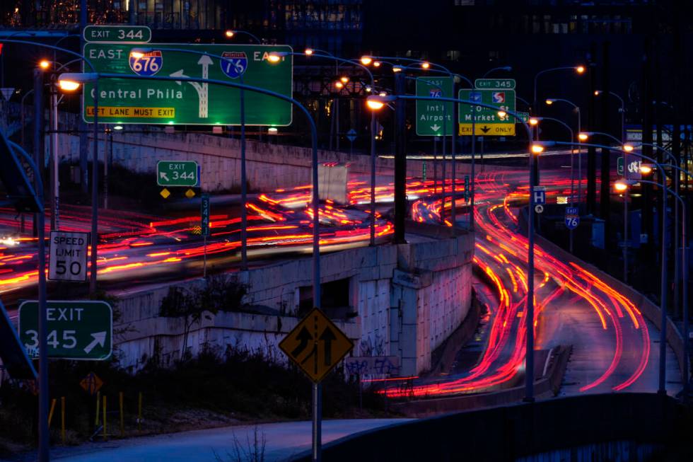 In this photo made with a long exposure, motor vehicles move along Interstate 76 ahead of the T ...