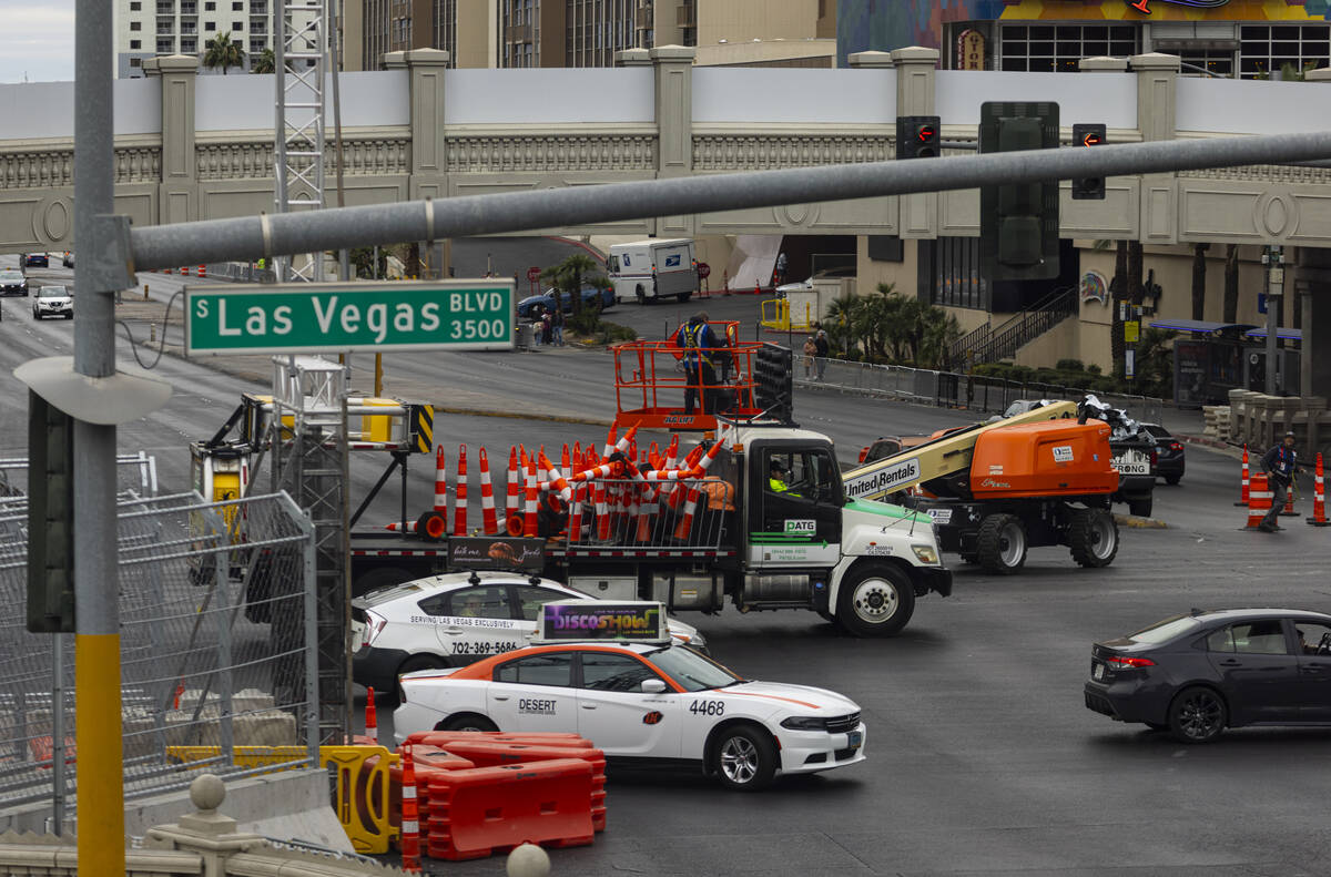 Crews work to take down the Formula One Las Vegas Grand Prix track along Las Vegas Boulevard at ...