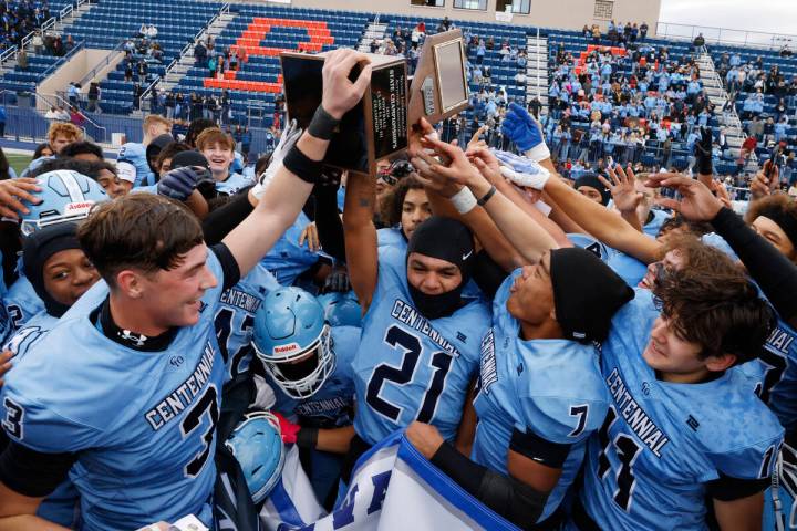 Centennial High players celebrate their Class 5A Division III football state championship win a ...