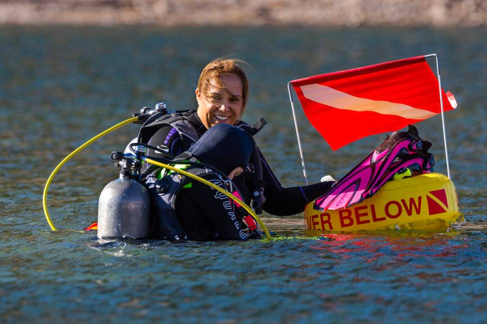 Kim Moronen smiles as her daughter Elanor Moronen, 11, gears up for a dive with Sin City Scuba ...