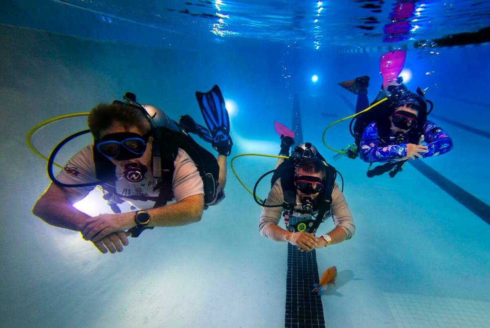 Sin City Scuba members, from left, Curtis Snaper, John Sivia and Erin Sivia demonstrate underwa ...