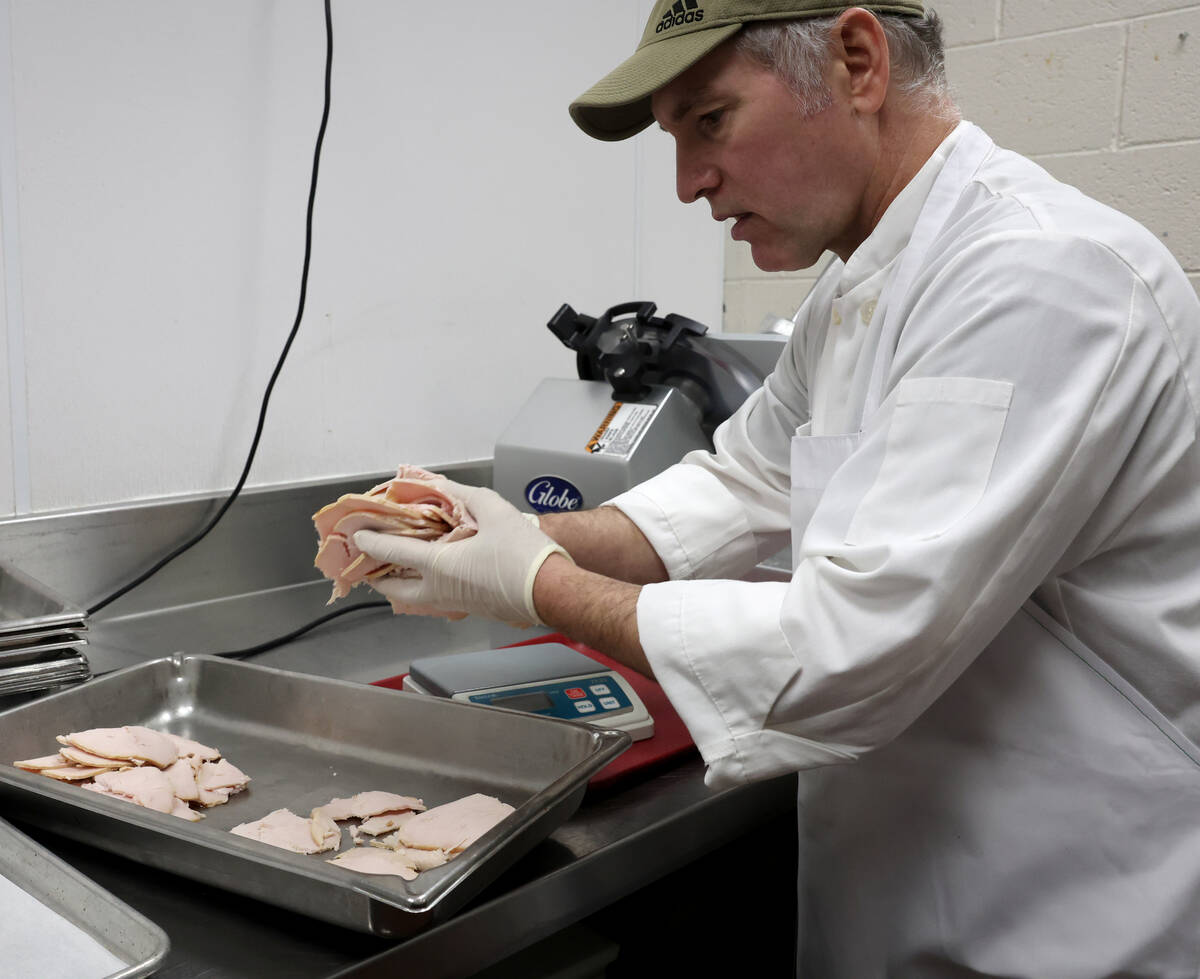 Sous chef Neil Mockovak prepares turkey for 700 Thanksgiving meals at Catholic Charities of Sou ...