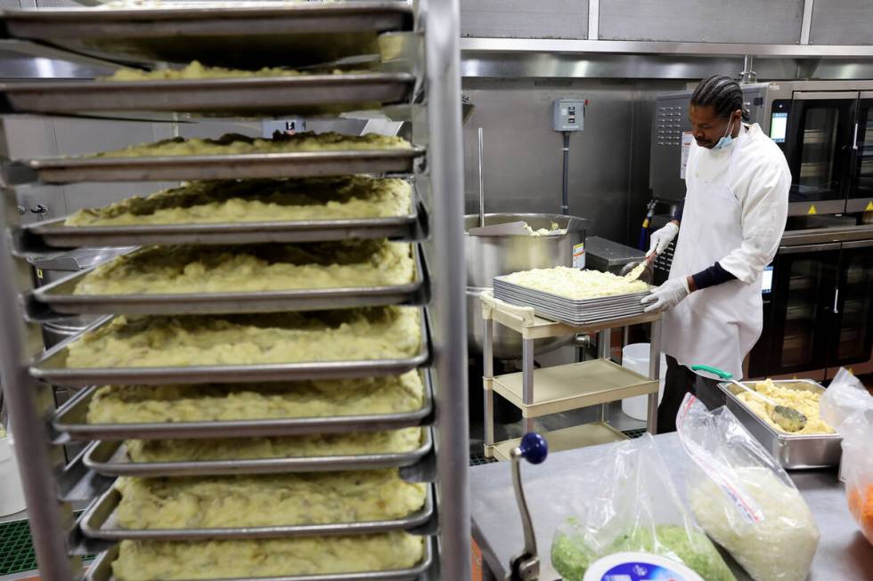 Cook Quincy McGee prepares mashed potatoes for 700 Thanksgiving meals at Catholic Charities of ...