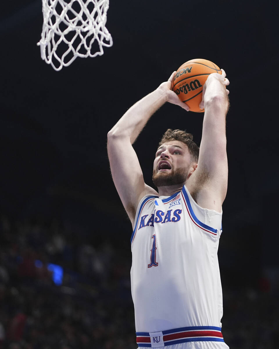 Kansas center Hunter Dickinson shoots during the first half of an NCAA college basketball game ...