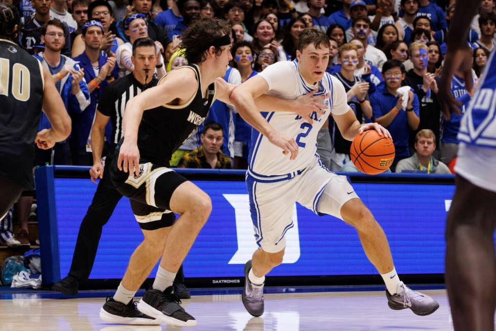 Duke's Cooper Flagg (2) drives against Wofford's Jackson Sivills (0) during the second half of ...