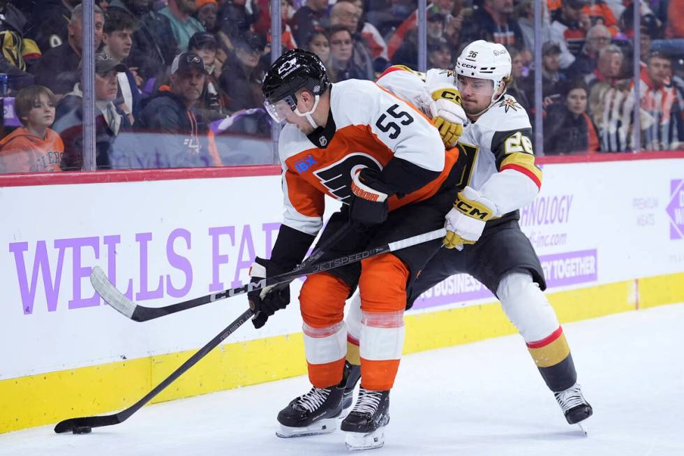 Philadelphia Flyers' Rasmus Ristolainen, left, tries to keep the puck away from Vegas Golden Kn ...