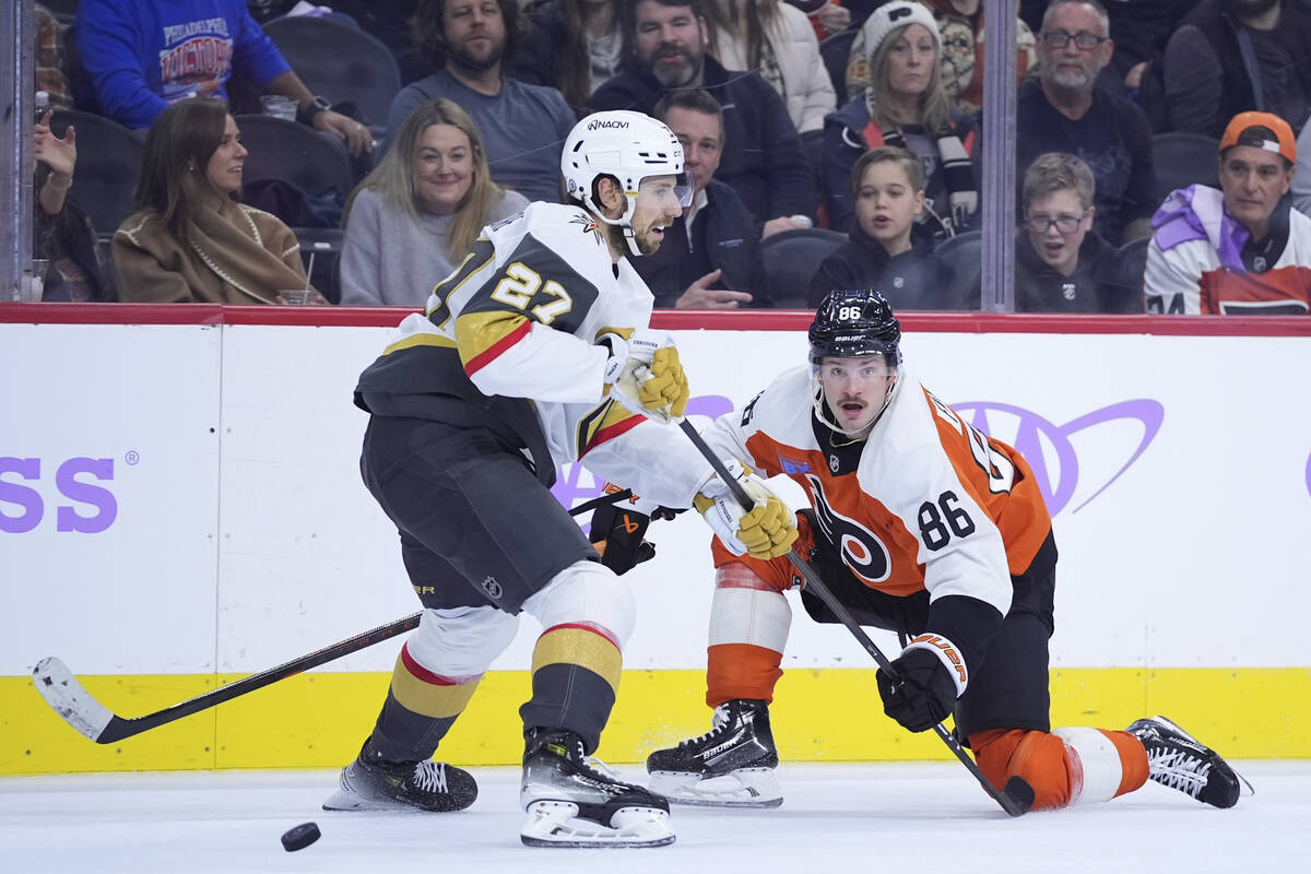 Philadelphia Flyers' Joel Farabee, right, and Vegas Golden Knights' Shea Theodore battle for th ...