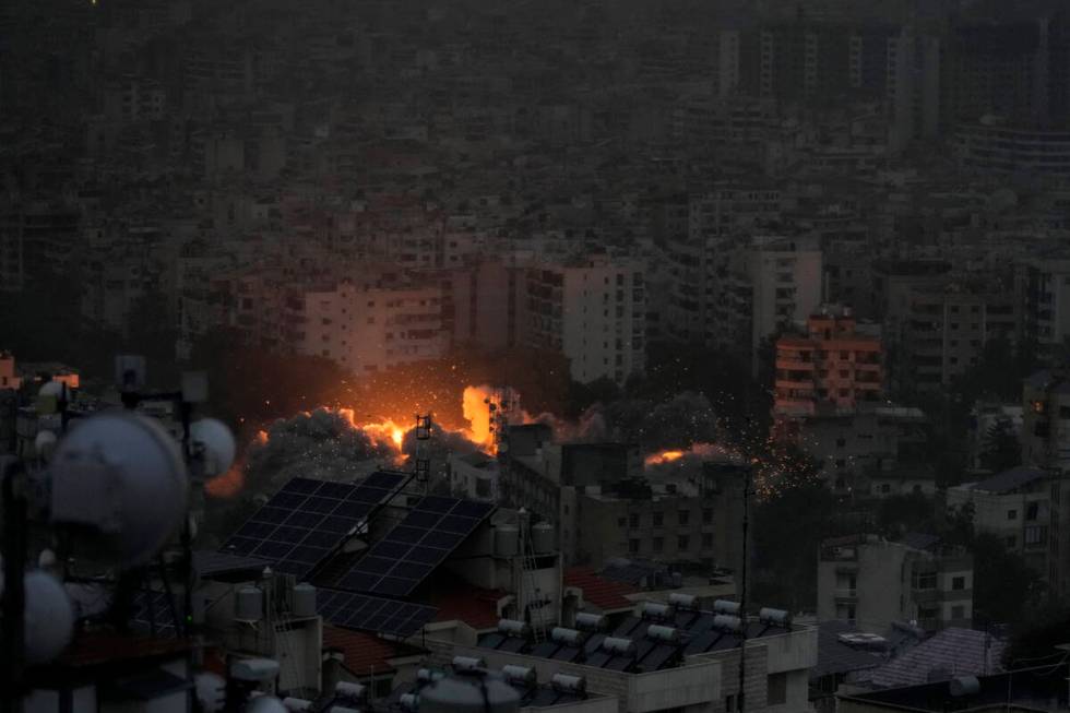 Smoke and flame rise after an Israeli airstrike on Dahiyeh, in Beirut, Lebanon, Monday, Nov. 25 ...