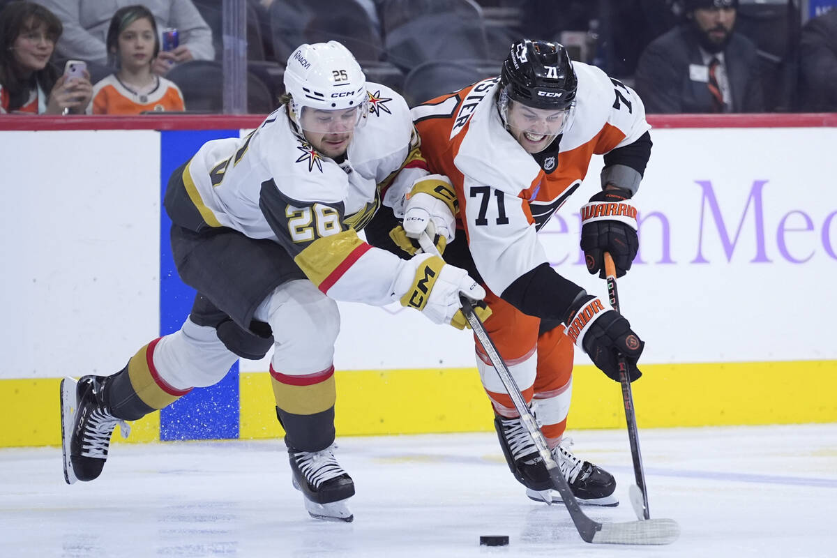 Philadelphia Flyers' Tyson Foerster, right, and Vegas Golden Knights' Alexander Holtz battle fo ...