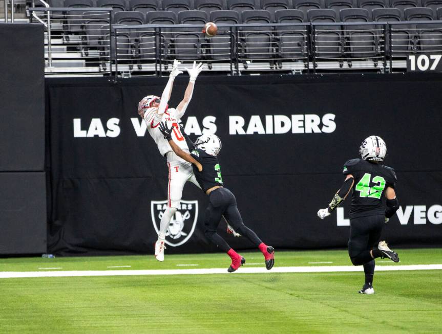 Truckee senior Jackson Wicks (0) grabs a touchdown pass over the top of SLAM Academy senior Cho ...