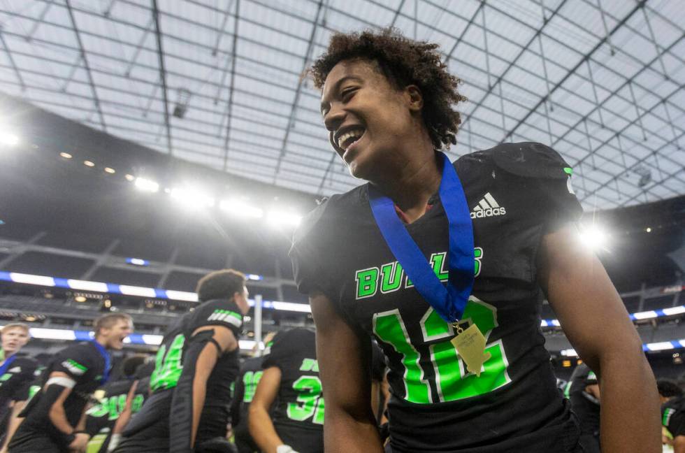 SLAM Academy senior Damien Nevil (12) celebrates after winning the Class 3A football state cham ...