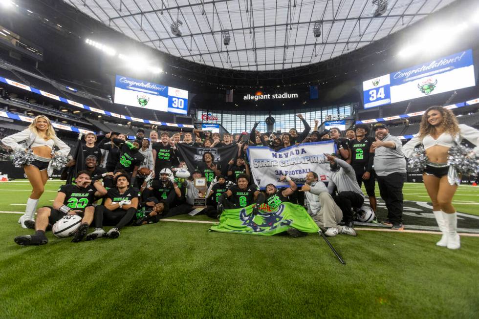 SLAM Academy celebrates after winning the Class 3A football state championship game against Tru ...