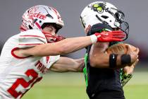 Truckee senior Chase Rothery, left, attempts to tackle SLAM Academy junior Alaijah Young, right ...