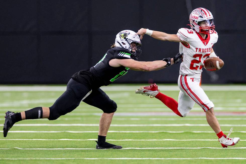 SLAM Academy senior Dylan Tondreau, left, attempts to tackle Truckee senior Jace Estabrook, rig ...