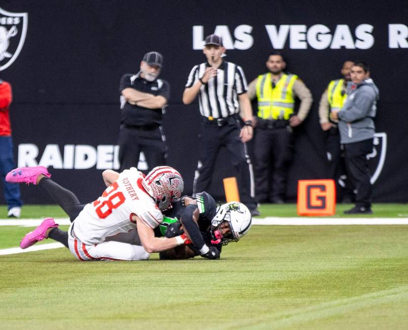 SLAM Academy senior Damien Nevil, right, dives for a touchdown during the Class 3A football sta ...