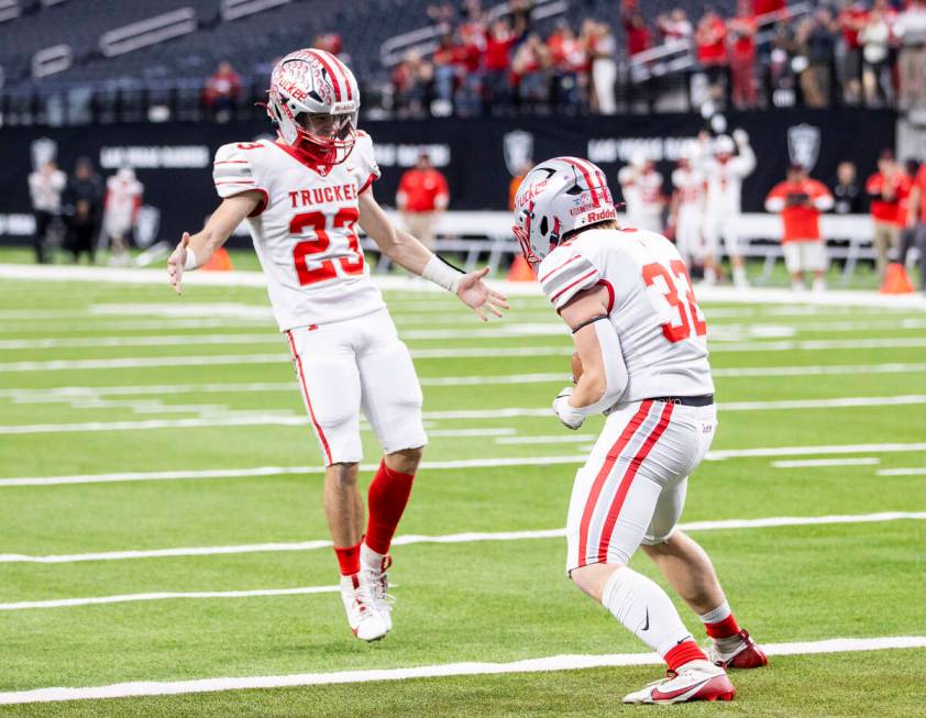 Truckee senior Colby Jitloff (32) celebrates a touchdown with senior Jace Estabrook (23) during ...