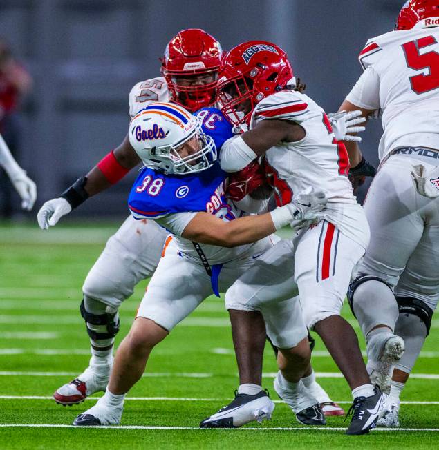 Arbor View running back Nylen Johnson (28) is wrapped up by Bishop Gorman defensive lineman Kea ...