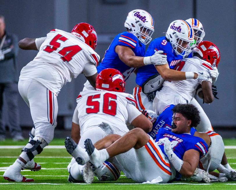 Arbor View running back Kamareion Bell (0) is stopped by Bishop Gorman linebacker Aloisio Malui ...