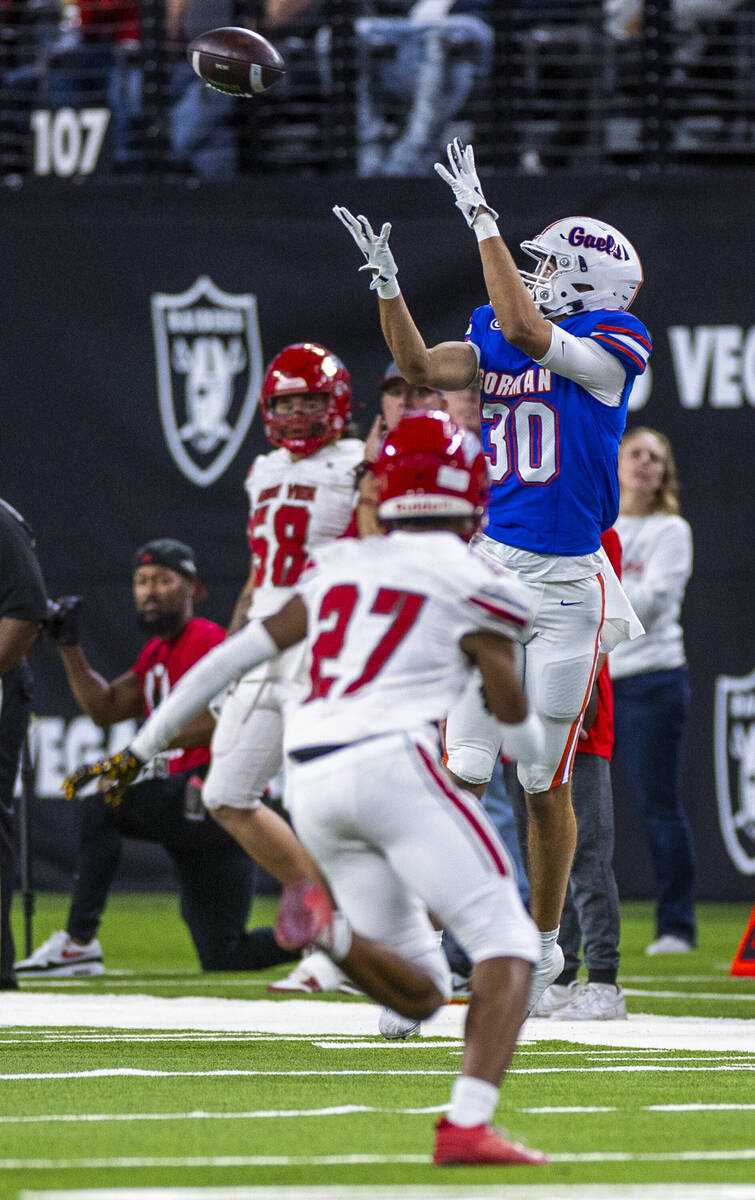 Bishop Gorman wide receiver Derek Meadows (30) hauls in a long pass as Arbor View safety Izaiah ...