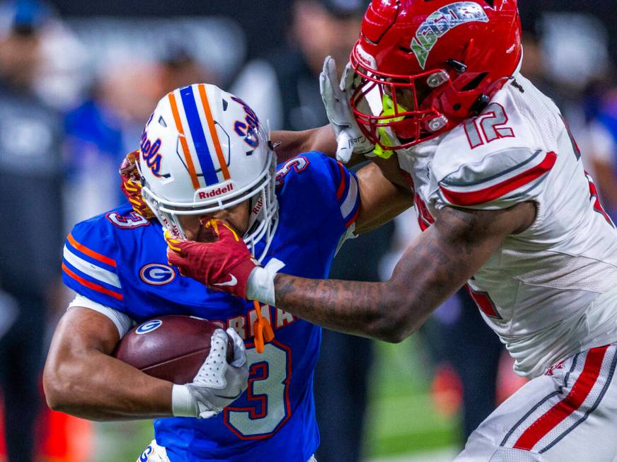 Bishop Gorman running back Terrance Grant (3) and Arbor View safety Damien Dixon Jr. (12) trade ...