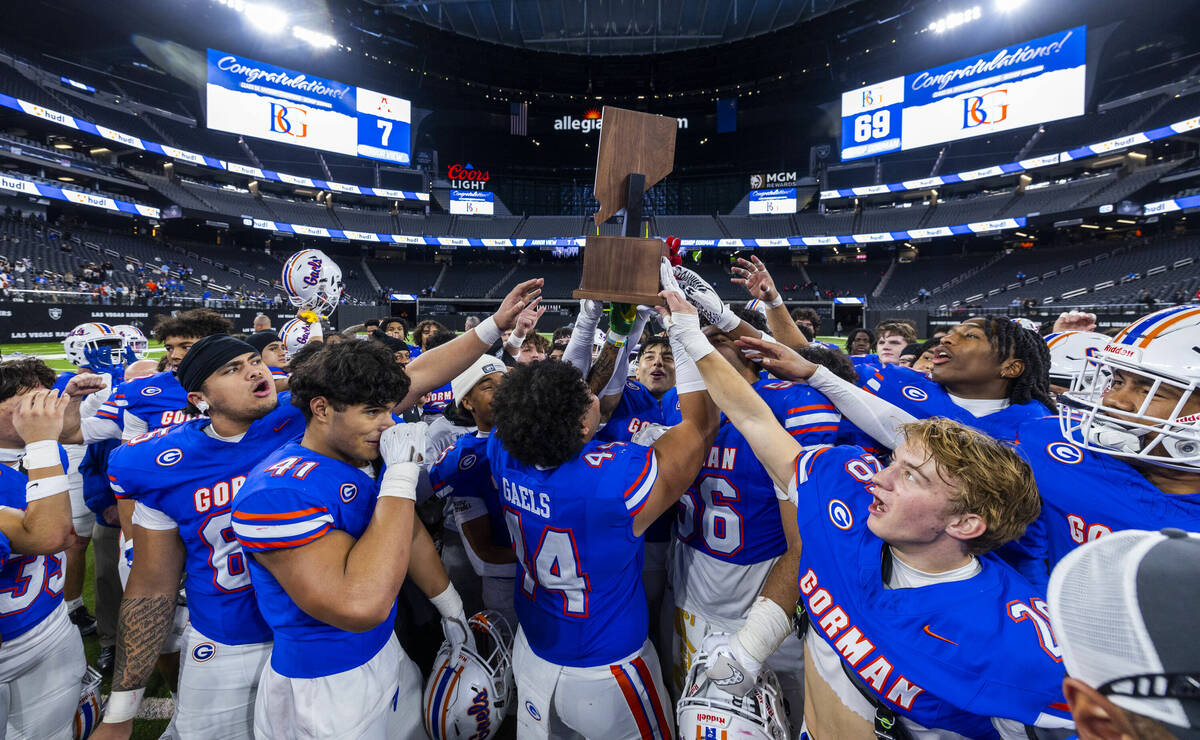 Bishop Gorman hoist their trophy after their 69-7 win over Arbor View for another Class 5A Divi ...