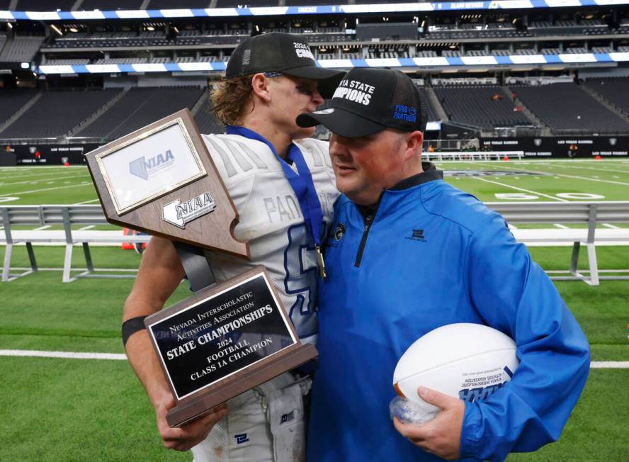 Pahranagat Valley quarterback Jesse Stewart (5) and head coach Brett Hansen congratulate each o ...