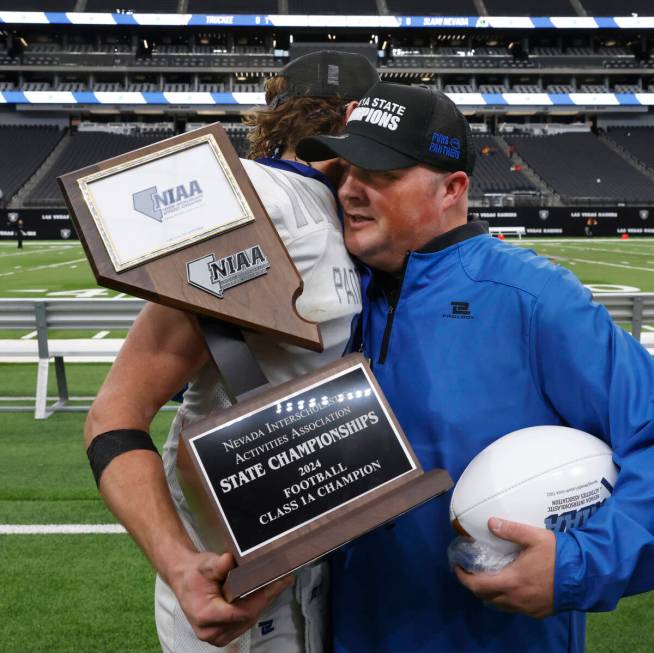 Pahranagat Valley quarterback Jesse Stewart (5) and head coach Brett Hansen congratulate each o ...