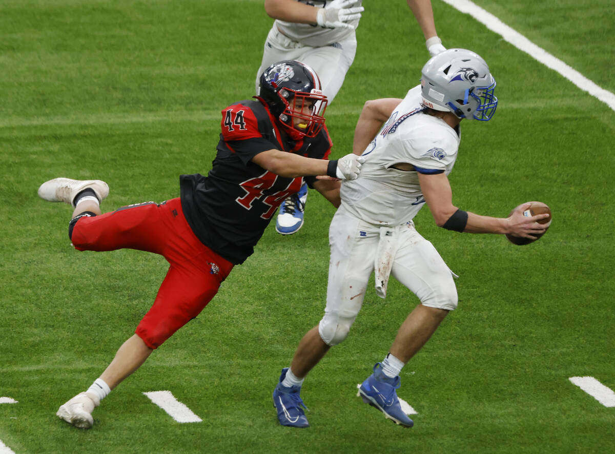 Pahranagat Valley quarterback Jesse Stewart (5) is taken down by Tonopah tight end Rhyston Wall ...