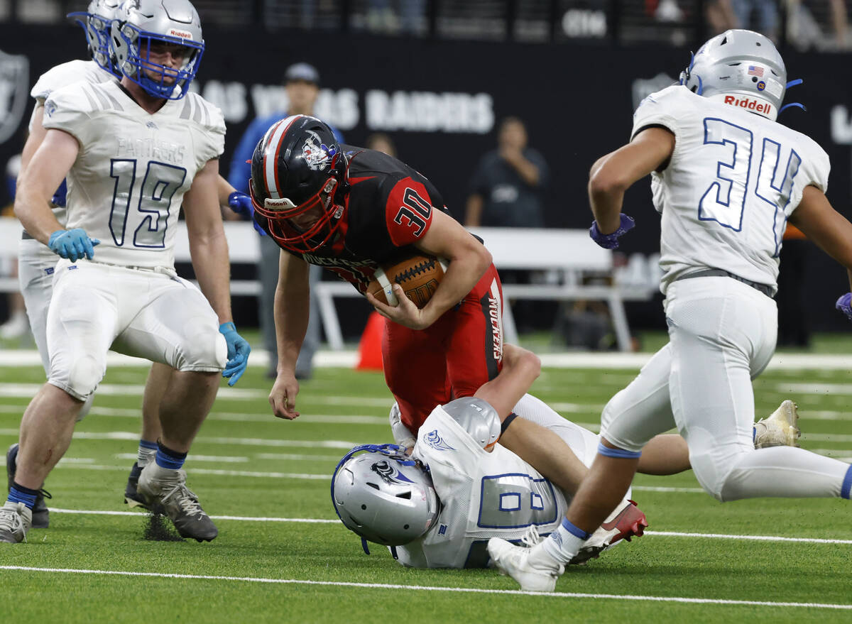 Tonopha running back Dustin Otteson (30) is taken down by Pahranagat Valley defensive back Jaco ...