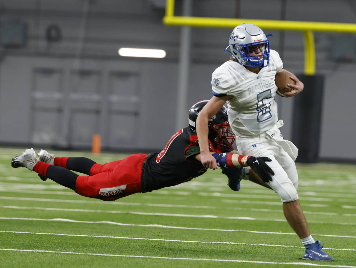 Pahranagat Valley quarterback Jesse Stewart (5) runs with the ball as Tonopah linebacker Brekke ...