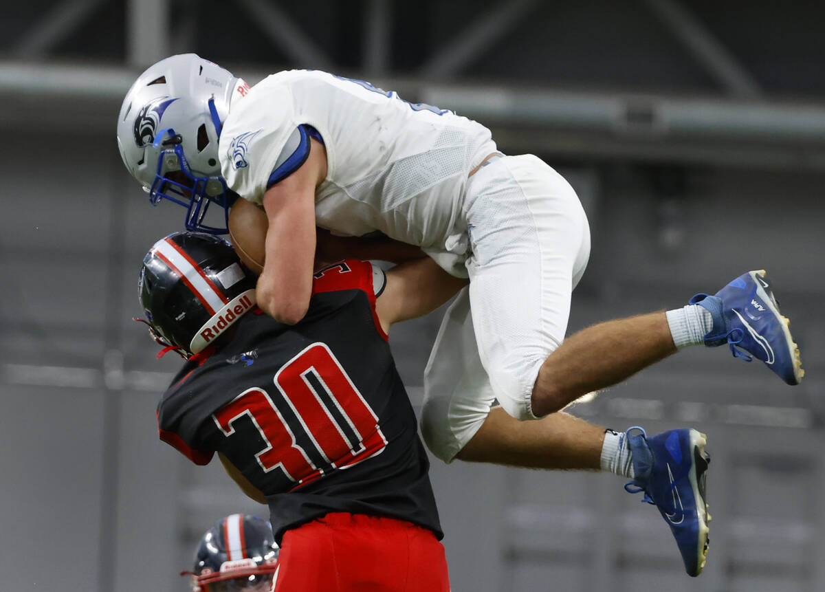 Tonopah defensive back Dustin Otteson (30) tackles Pahranagat Valley quarterback Jesse Stewart ...