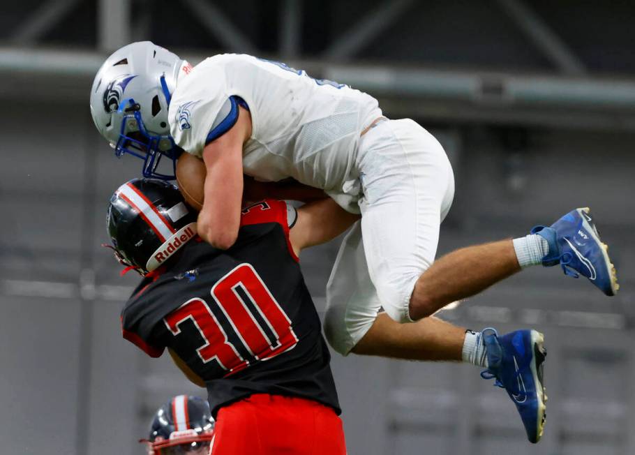 Tonopah defensive back Dustin Otteson (30) tackles Pahranagat Valley quarterback Jesse Stewart ...