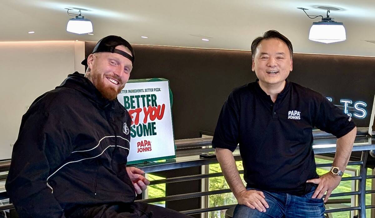 Maxx Crosby and Doug Pak pose for a photo. (Courtesy Papa Johns)