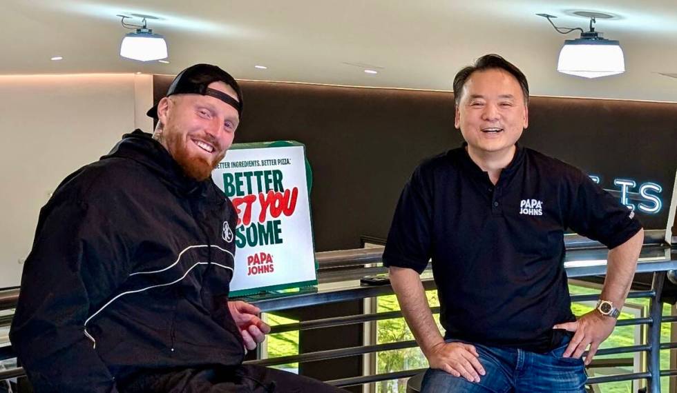 Maxx Crosby and Doug Pak pose for a photo. (Courtesy Papa Johns)