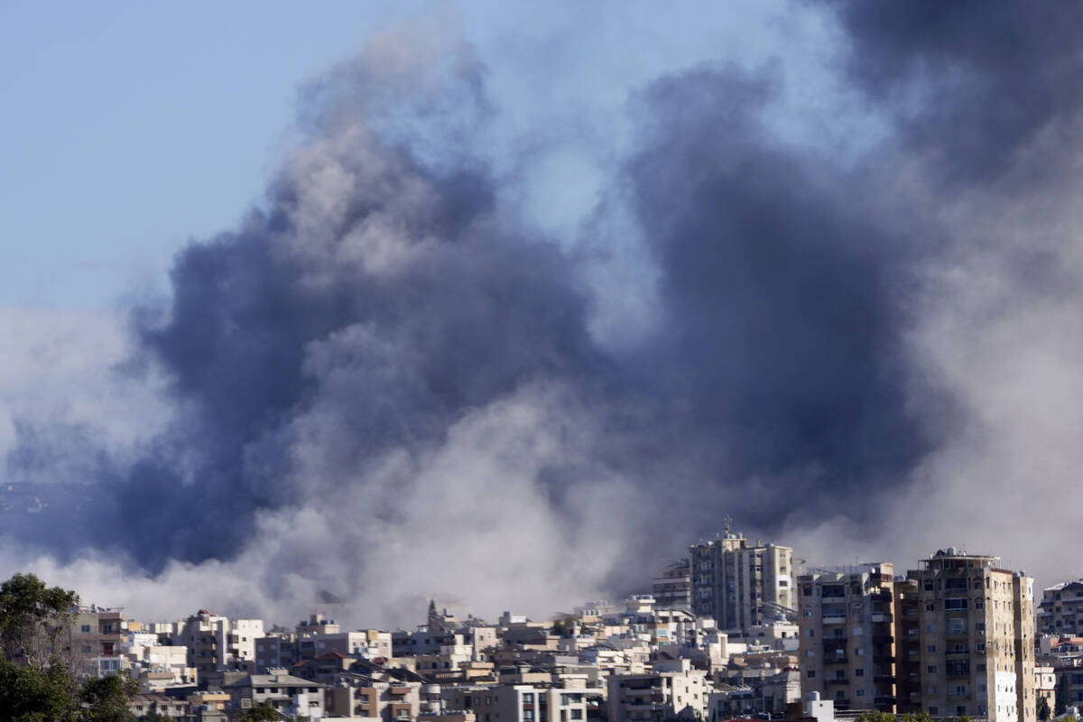 Smoke rises between buildings hit in Israeli airstrikes in Hosh neighbourhood, in Tyre, south L ...